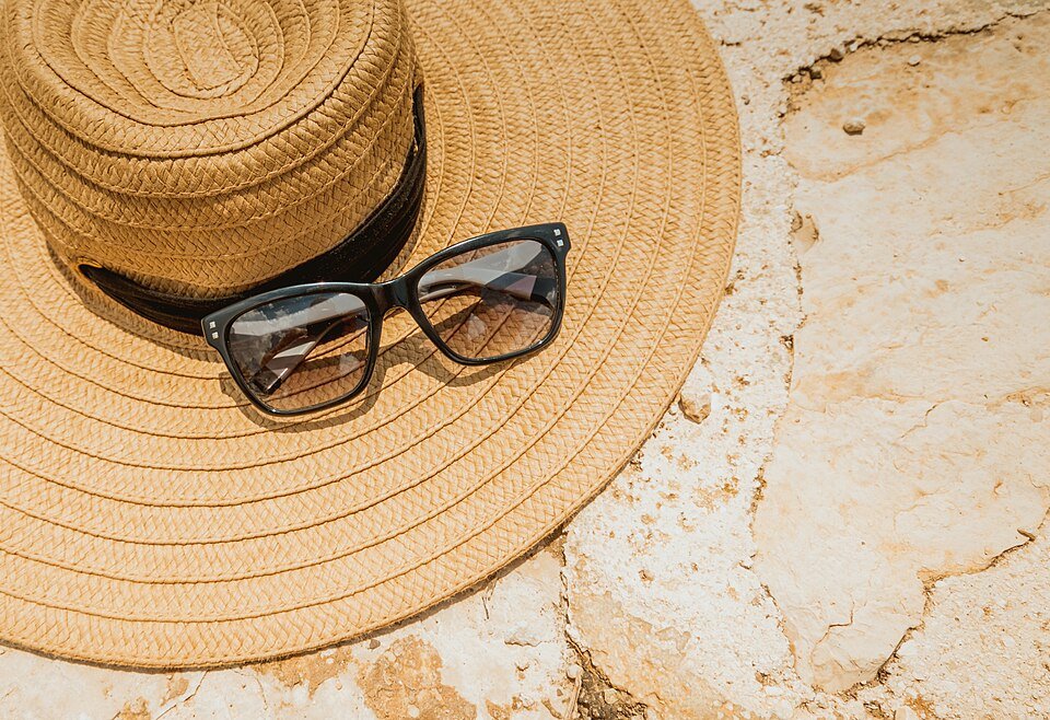 Sombrero de paja y gafas de sol en la playa — Atelier SANLILAS